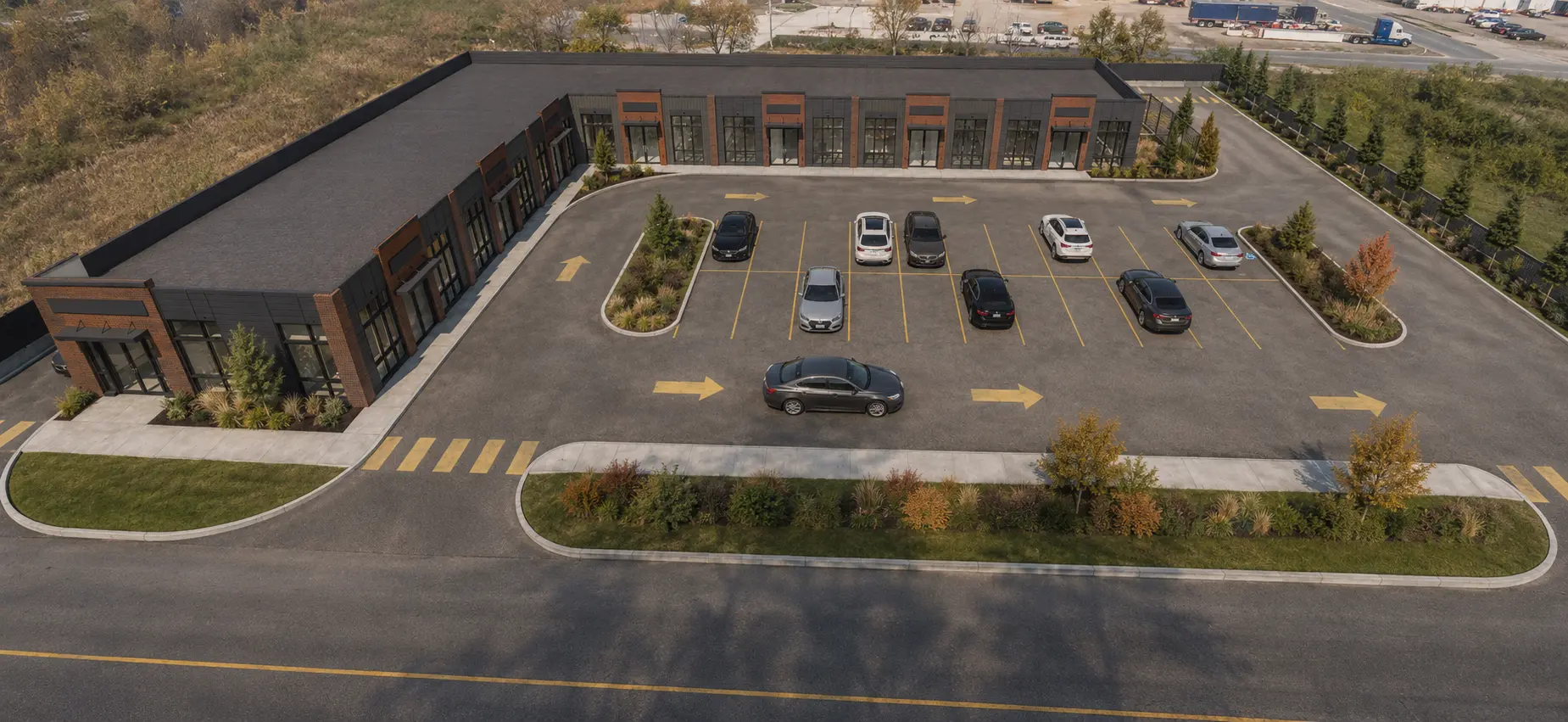 Aerial architectural rendering showing the Three Hills Crossing building, parking court and site circulation