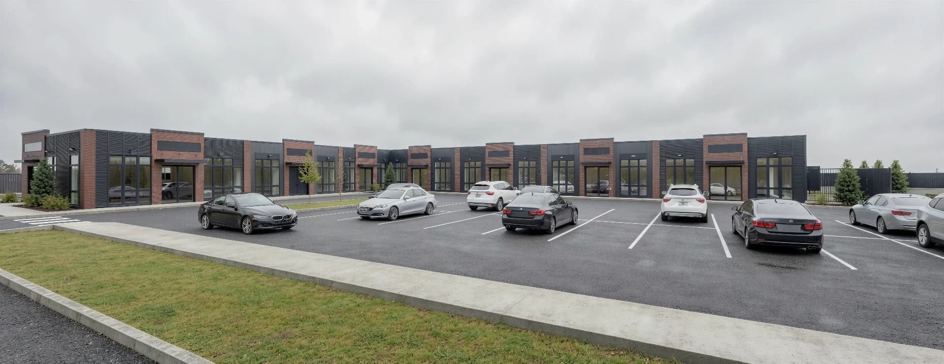 Full frontage — The complete storefront elevation across the parking court